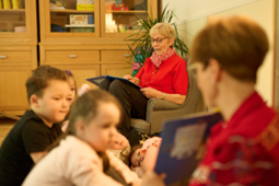 Eine Erzieherin liest Kindern vor.