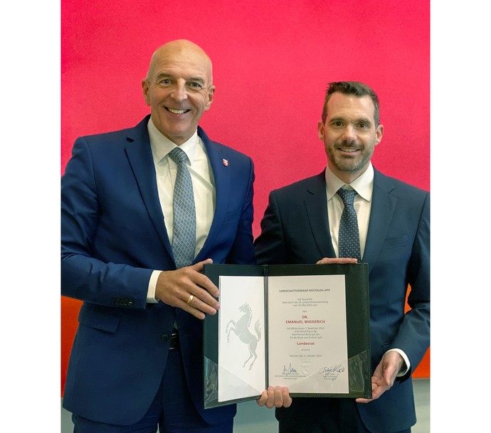 Dr. Georg Lunemann, der Direktor des LWL mit Dr. Emanuel Wiggerich. In ihren Händen präsentieren sie die Ernennungsurkunde.